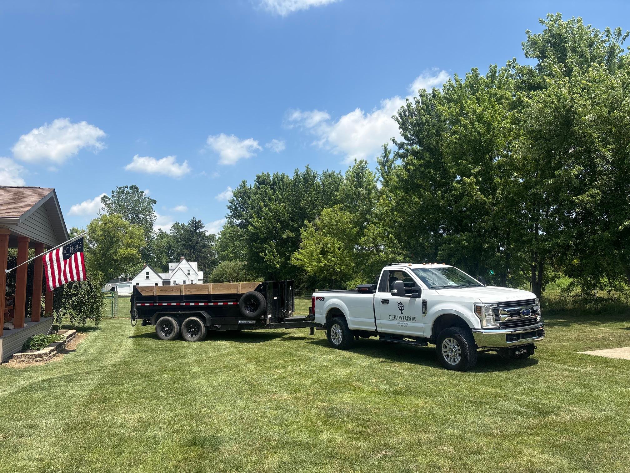 Steen's Lawn Care LLC truck and trailer parked on a freshly mowed lawn in Ashland, OH